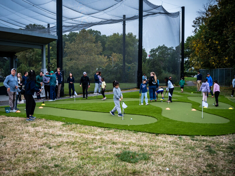 Young golfers and officials cut the ribbon on the refurbished greens at the Junior Golf Center in Bay Ridge