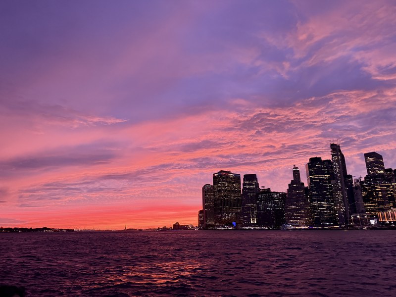 Pink and purple sunset over the Lower Manhattan skyline seen from the Brooklyn waterfront