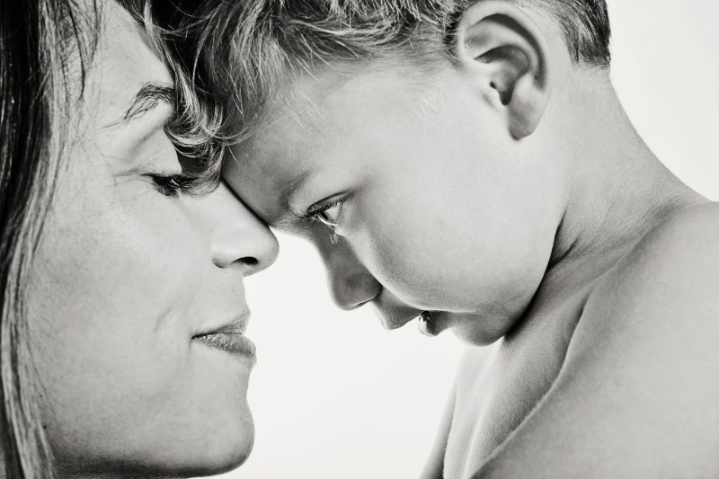 A mother and young child touching foreheads in a black-and-white portrait at Daysee photo studio