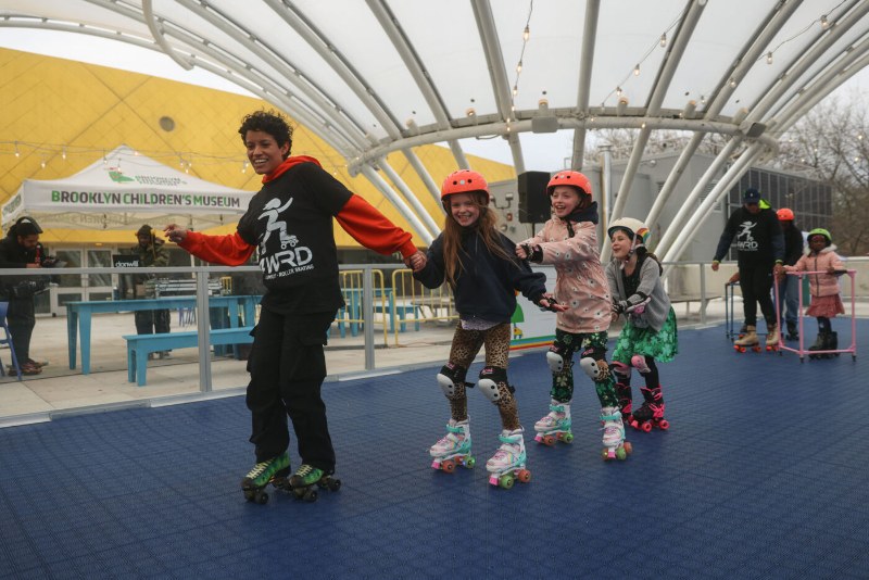 Families roller skating on the rooftop terrace rink at Brooklyn Children’s Museum