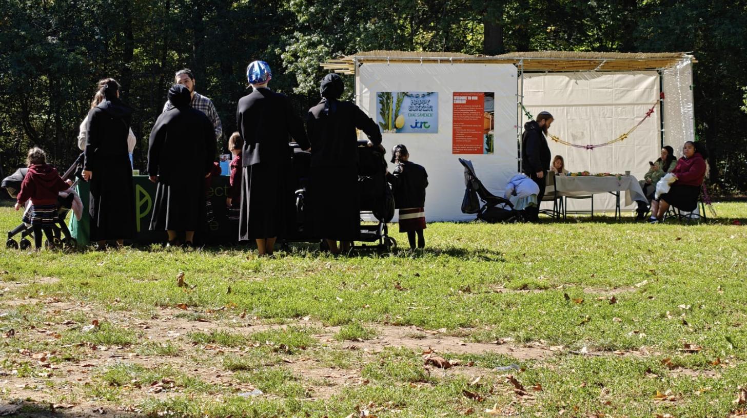 Families gather at a sukkah on the Carousel Lawn in Prospect Park