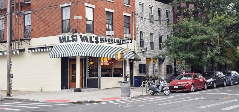 The green-and-white striped awning of Val’s Diner & Bar on Van Brunt Street in Red Hook