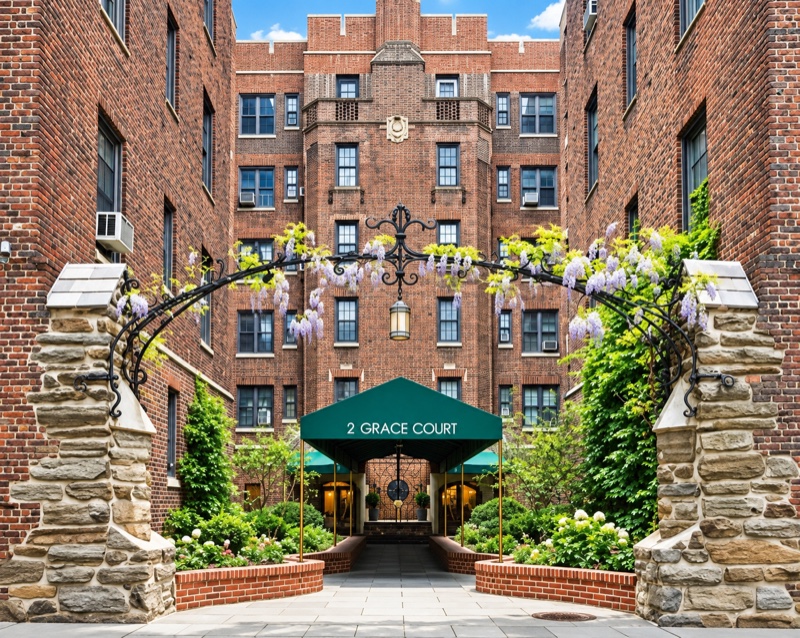 The courtyard entrance and green awning of 2 Grace Court in Brooklyn Heights
