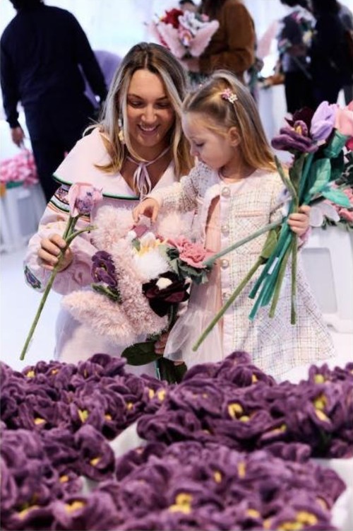 A mother and daughter holding flowers at Cj Hendry’s Flower Market