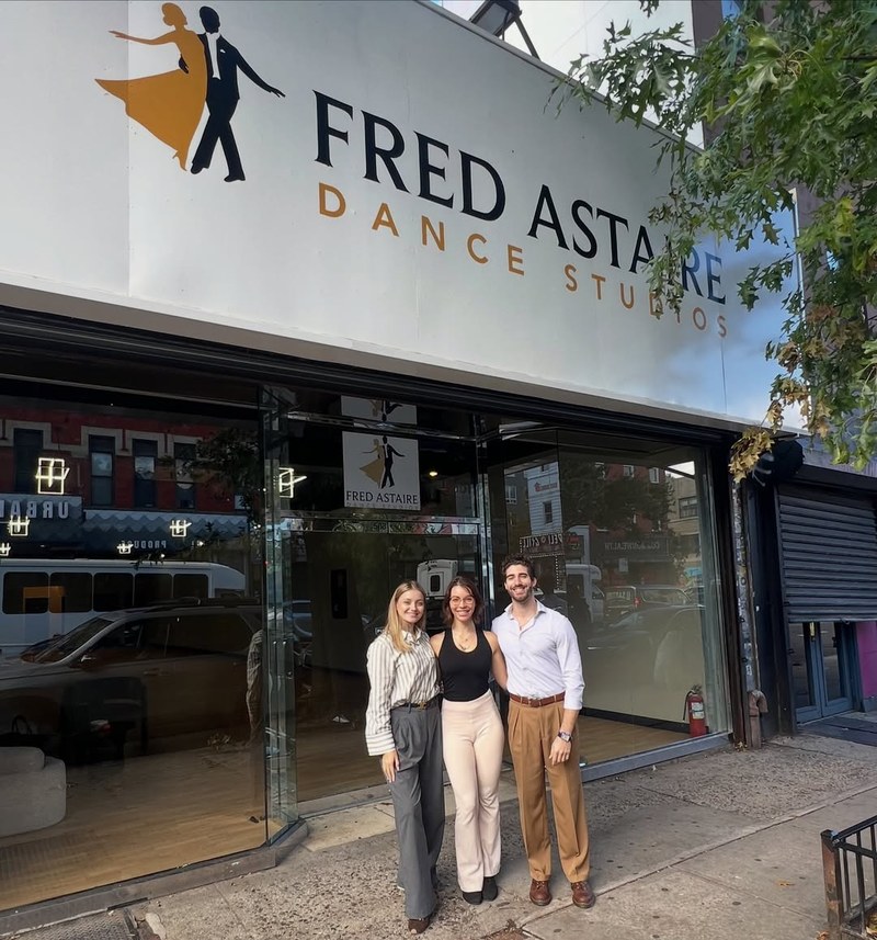Three instructors stand in front of the new Fred Astaire Dance Studios storefront on Fifth Avenue in Park Slope