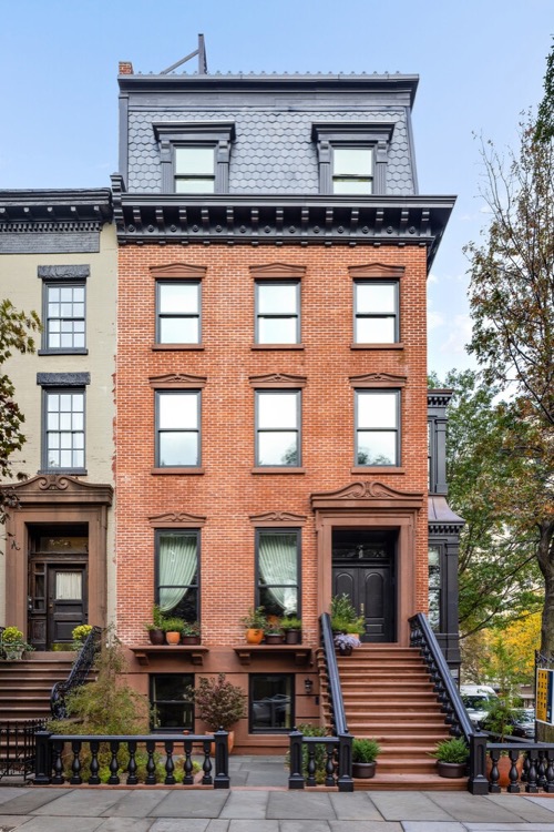 The brick facade and mansard roof of One Monroe Place in Brooklyn Heights