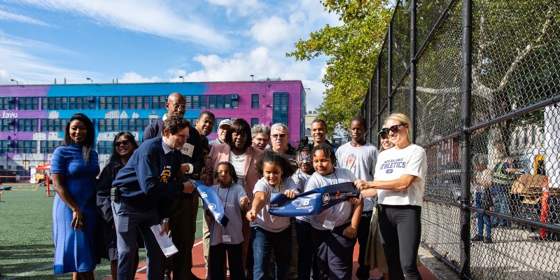Officials and students at the tape-breaking for the refurbished Star Spangled Playground track in Brooklyn