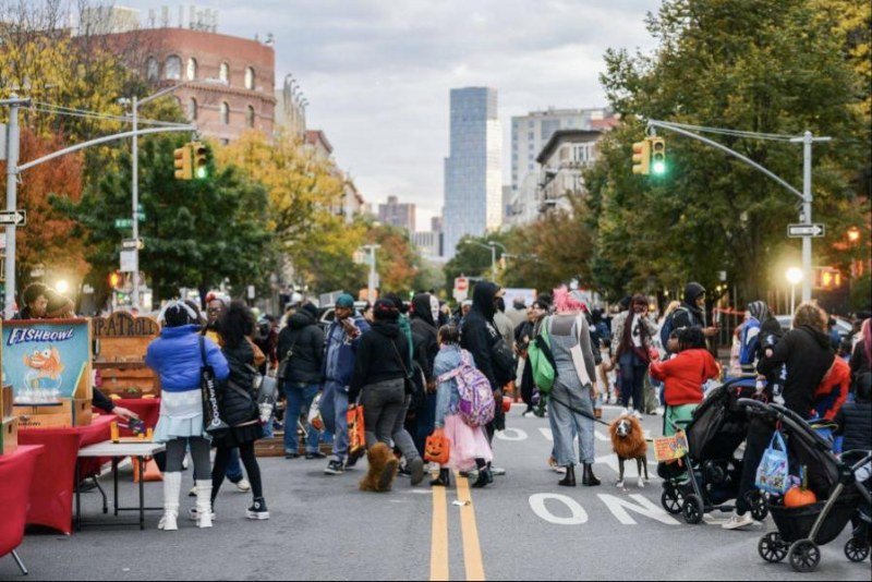 Kids and adults in Halloween costumes on a street closed to cars for NYC DOT’s Trick-or-Streets
